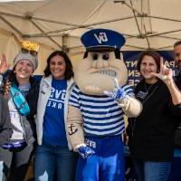 Alums posing for a photo with Louie the Laker.